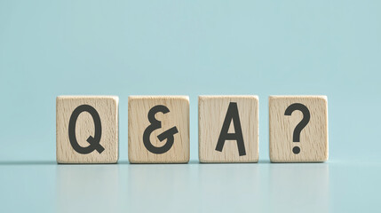 four wooden cubes with the letters Q and A on the bright surface  q and - short for Question Answer

