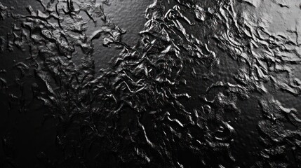 Obraz premium Abstract texture featuring a dark, glossy surface with intricate, wavy patterns.
