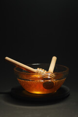 Yellow liquid honey dripping from the honey spoon	