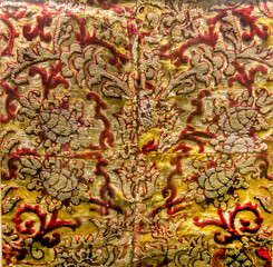 The background of the fabric is antique with gold embroidery in red and yellow. Design backgrounds textures.