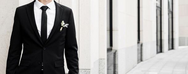  groom in black jacket and tie