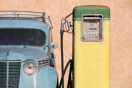 Oingt, France - March 12, 2014: Old and vintage gas pump with a citroen car in France 