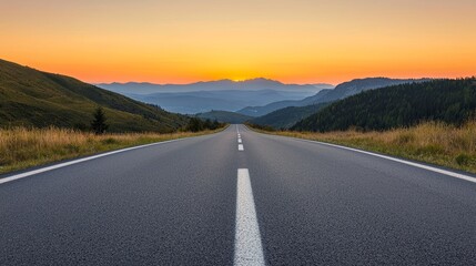 Naklejka premium Scenic road leading into stunning sunset over distant mountains