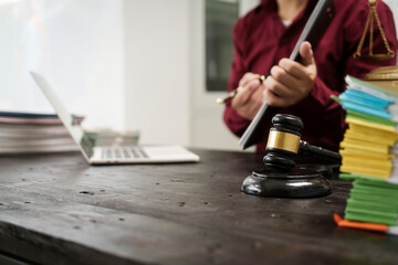 A male lawyer is working at his desk on an online judicial review, focusing on justice, fairness, and legal compliance.He reviews cases, contracts, and legal matters based on general law principles