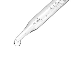 Dripping cosmetic serum from pipette on white background