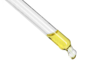 Dripping essential oil from pipette on white background