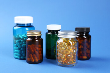 Pharmacist. Different pills in plastic bottles on blue background