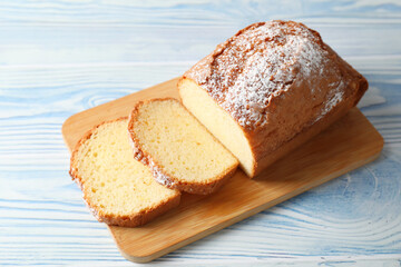 Freshly baked sponge cake on light blue wooden table