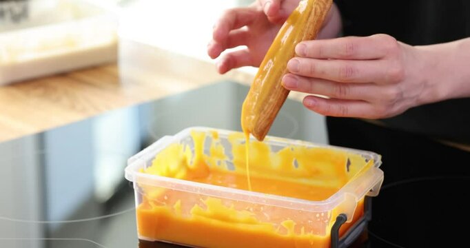 Delicious eclair and covered with yellow glaze