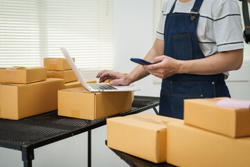 A man is working at his desk, preparing parcel boxes for shipment. He checks and packs items carefully, using shockproof materials, and attaches labels before sending them to customers via EMS.