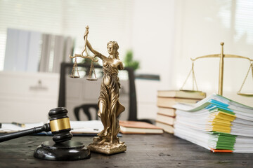 A lawyer's desk in the office is filled with legal documents.The lawyer provides consultations on...