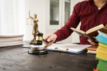 A male lawyer is working at his desk on an online judicial review, focusing on justice, fairness, and legal compliance.He reviews cases, contracts, and legal matters based on general law principles