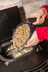 Woman filling a pellet stove
