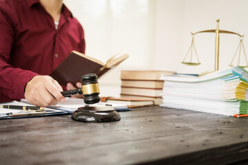 A male lawyer is working at his desk on an online judicial review, focusing on justice, fairness, and legal compliance.He reviews cases, contracts, and legal matters based on general law principles