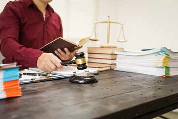 A male lawyer is working at his desk on an online judicial review, focusing on justice, fairness, and legal compliance.He reviews cases, contracts, and legal matters based on general law principles