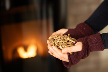 Woman filling a pellet stove