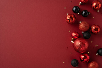 A festive scene with red and black Christmas ornaments on a rich red background symbolizing holiday spirit and elegance