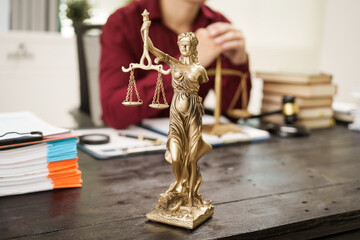 A male lawyer is working at his desk on an online judicial review, focusing on justice, fairness,...