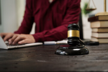 A male lawyer is working at his desk on an online judicial review, focusing on justice, fairness, and legal compliance.He reviews cases, contracts, and legal matters based on general law principles