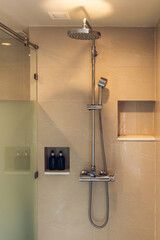 Shower at bathroom. Bathroom interior with shower stall and soap Gel bottle. Luxury fully tiled...