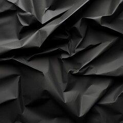 Obraz premium Close-up of textured black crumpled paper, ideal for backgrounds, designs, and artistic projects.