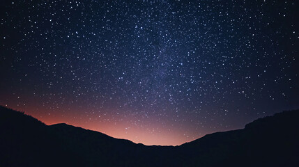 A starry sky background with a silhouette of mountains, perfect for nighttime themes.