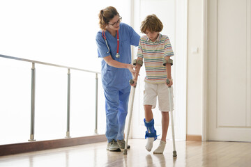 Injured child on crutches. Boy in cast on foot