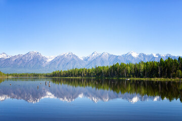 Fototapeta premium Russia. Landscape with mountains reflecting in the water on summer day. Buryatia, Tunkinskaya valley