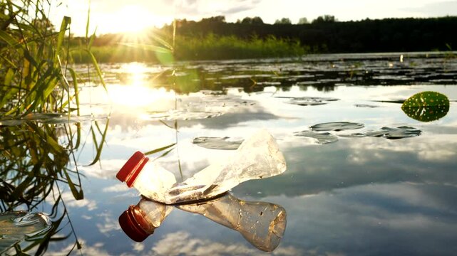 Plastic waste in lake. Ocean pollution, marine debris. Marine litter. Garbage plastic bottle in water of pond. Plastic marine debris. Marine plastic pollution. Microplastics groundwater poisoning.