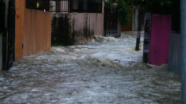 Alleyway flooded because of continuous heavy rainfall, flood water flowing in an alleyway flooding buildings in Kathmandu, Nepal during September monsoon 2024.