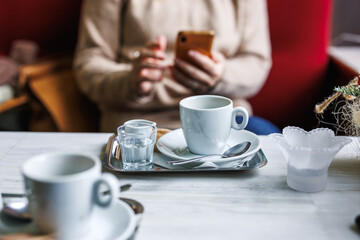 Coffee break. Woman using her smartphone in cafe