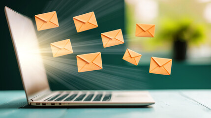 Email icons flying from laptop, symbolizing communication and connection