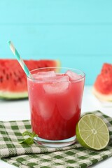Tasty watermelon drink in glass, fresh fruits and mint on white table