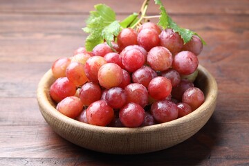 Fresh ripe grapes on wooden table, closeup