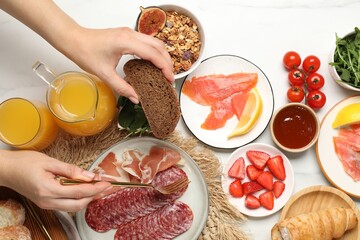 Woman having brunch at white table, top view