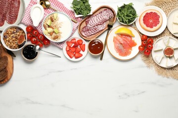Different tasty food served for brunch on white marble table, flat lay. Space for text