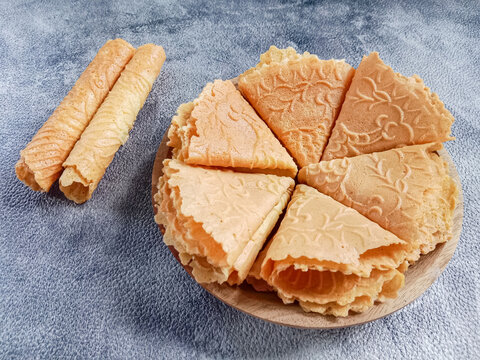 Kue semprong, Asian egg roll, sapit, sepit or kapit. Indonesian traditional wafer snack made by clasping egg batter using an iron mold.