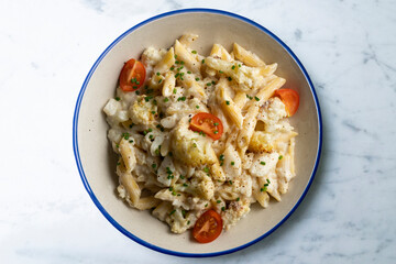 Macaroni and cheese with cauliflower. Top view table with  decoration.