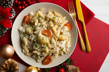 Macaroni and cheese with cauliflower. Top view table with Christmas decoration.