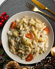 Macaroni and cheese with cauliflower. Top view table with Christmas decoration.