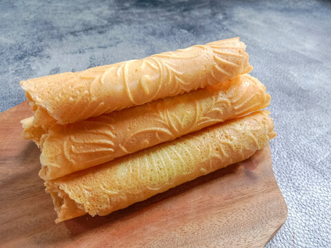 Kue semprong, Asian egg roll, sapit, sepit or kapit. Indonesian traditional wafer snack made by clasping egg batter using an iron mold.