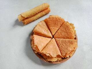 Kue semprong, Asian egg roll, sapit, sepit or kapit. Indonesian traditional wafer snack made by clasping egg batter using an iron mold.