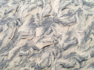 Wet sand texture with ripples. Natural background
