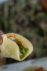 Military personnel showing off tacos