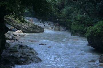 Fototapeta premium Beautiful views of the flowing river at Tapkeshwar Temple in Dehradun from different angles.