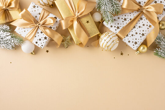 Beautifully wrapped gold and white presents with ribbons, surrounded by elegant festive ornaments and decorations, embodying the spirit of Christmas and celebration.