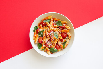 Pasta penne alla arrabiata with tomatoes, basil and parmesan cheese. Healthy Eating. Vegetarian Food.