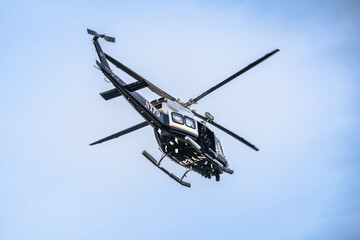 NYPD search and rescue helicopter in action view, New York city © xbrchx