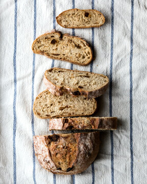 Sliced artisan bread on a striped linen cloth.