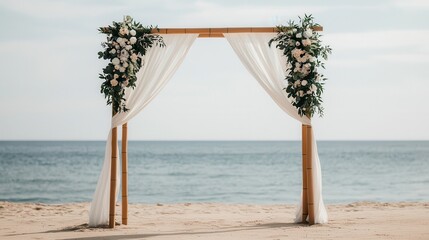 Rustic wedding altar adorned with flowers on a sandy beach by the ocean.